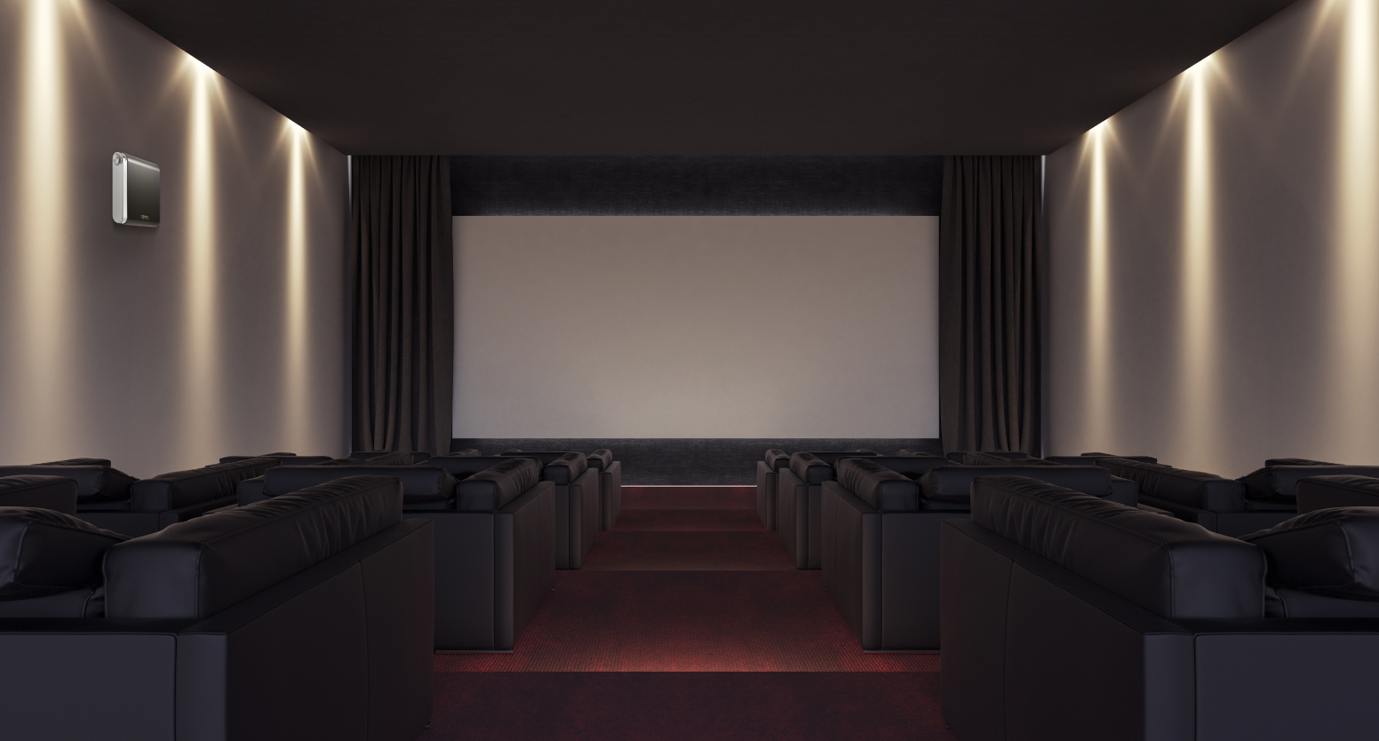 소파가 놓여있는 영화관 안 좌측 벽면에는 넓은 공간에 대해 관리가 가능한 세스코(CESCO)의 공간 방향기 에어퍼퓸이 설치되어 있습니다.